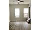 Living room featuring durable flooring, complemented by abundant natural light and convenient access to stairs at 302 S Randolph St, Indianapolis, IN 46201