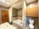 Bathroom featuring a tub with tile surround, granite counters, toilet, wooden cabinet, and shower at 3040 Old Morgantown Rd, Martinsville, IN 46151