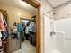 Bathroom featuring a large shower, wooden trim, and walk-in closet with plentiful storage space at 3040 Old Morgantown Rd, Martinsville, IN 46151