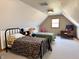 Bedroom with angled ceilings and two beds, offering plenty of space for sleeping and relaxing at 3040 Old Morgantown Rd, Martinsville, IN 46151