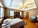 Cozy bedroom with hardwood floors, tray ceilings, comfortable armchair, and bookshelf filled with decorations at 3040 Old Morgantown Rd, Martinsville, IN 46151