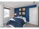 Cozy bedroom featuring blue accent wall and decor, complemented by a window at 3547 Planck Cir, Danville, IN 46122