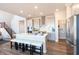Open kitchen features an island with seating, stainless steel appliances, modern cabinets, and pantry at 3547 Planck Cir, Danville, IN 46122
