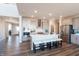 Modern kitchen with central island and breakfast bar, pendant lighting, white backsplash, and stainless appliances at 3547 Planck Cir, Danville, IN 46122