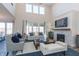 Bright living room with a fireplace, large windows, high ceilings, stylish furnishings and ample natural light at 3547 Planck Cir, Danville, IN 46122