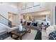 Bright, open-concept living room showcasing a modern kitchen, neutral decor, and elegant furnishings at 3547 Planck Cir, Danville, IN 46122