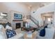 Cozy living room features a fireplace, TV, comfortable seating, and staircase to upper level at 3547 Planck Cir, Danville, IN 46122