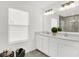 Bright bathroom with double vanity, sleek white cabinets, and a large mirror at 3548 Planck Cir, Danville, IN 46122