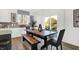 Well lit dining room with a view to the backyard, rustic table, a bench and modern finishes at 3548 Planck Cir, Danville, IN 46122