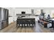 Spacious kitchen featuring a central island, modern appliances, ample counter space, and an adjacent dining area at 3548 Planck Cir, Danville, IN 46122