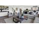 Inviting living room featuring stylish armchairs, contemporary decor, and an open view to the kitchen at 3548 Planck Cir, Danville, IN 46122