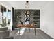 Modern home office with decorative wallpaper, custom shelving, stylish furniture, and a bright window view at 3548 Planck Cir, Danville, IN 46122