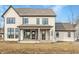 Exterior home elevation showcasing a covered porch area accessible by two doors and large windows at 3787 Cherwell Dr, Zionsville, IN 46077