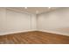 This empty basement features wood floors, neutral walls, white trim, and outlets for easy customization at 3787 Cherwell Dr, Zionsville, IN 46077