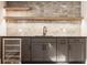 The basement bar area features a modern wine fridge, dark cabinets, and a stylish tile backsplash at 3787 Cherwell Dr, Zionsville, IN 46077