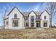 Stunning new construction home with a painted brick exterior and black trim windows at 3787 Cherwell Dr, Zionsville, IN 46077