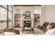 Bright living room with a stone fireplace, floating shelves, and large window views at 3787 Cherwell Dr, Zionsville, IN 46077