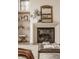 Elegant stone fireplace with a decorative mirror and floating shelves at 3787 Cherwell Dr, Zionsville, IN 46077