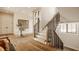 Welcoming foyer featuring hardwood floors, a staircase, and a round table with a floral arrangement at 3787 Cherwell Dr, Zionsville, IN 46077