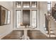 Welcoming foyer with hardwood floors and a staircase with wood and iron railing at 3787 Cherwell Dr, Zionsville, IN 46077