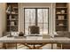 Cozy home office featuring a marble desk, built-in bookshelves, and a large window view at 3787 Cherwell Dr, Zionsville, IN 46077