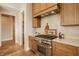 Stylish kitchen showcasing stainless steel appliances, wood cabinets, and marble countertops at 3787 Cherwell Dr, Zionsville, IN 46077