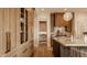 Elegant kitchen featuring wood cabinets, stainless steel appliances, and an island with a sink at 3787 Cherwell Dr, Zionsville, IN 46077