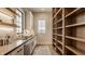 Open concept kitchen with stainless steel appliances, open shelving, and hardwood floors at 3787 Cherwell Dr, Zionsville, IN 46077