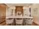 Modern kitchen island with pendant lighting, bar stools, and natural wood finishes at 3787 Cherwell Dr, Zionsville, IN 46077