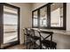 Kitchenette features granite counter with bar stool seating next to window and door that leads outside at 3787 Cherwell Dr, Zionsville, IN 46077