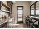 Bright kitchenette featuring granite counters, bar stool seating, cabinets, and a door that leads to the outside at 3787 Cherwell Dr, Zionsville, IN 46077