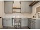 Laundry room featuring gray cabinets, a gray seat, and wooden shelving at 3787 Cherwell Dr, Zionsville, IN 46077