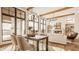 Open-concept living and dining area with large windows, wood beams, and hardwood floors at 3787 Cherwell Dr, Zionsville, IN 46077