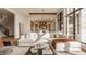 Bright, open living room features a large sofa, tall windows, and seamless flow to the kitchen at 3787 Cherwell Dr, Zionsville, IN 46077