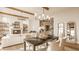 Cozy living and dining space with fireplace, stylish lighting, and hardwood flooring at 3787 Cherwell Dr, Zionsville, IN 46077