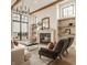 Comfortable living room features a fireplace, modern chandelier and floating shelves at 3787 Cherwell Dr, Zionsville, IN 46077
