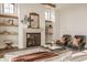 Cozy sitting area with a stone fireplace, floating shelves, and comfortable armchairs at 3787 Cherwell Dr, Zionsville, IN 46077