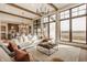 Spacious living room with large windows, wood beams, and an open-concept design at 3787 Cherwell Dr, Zionsville, IN 46077