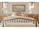 Bedroom with stylish decor, black-trimmed windows, decorative lamps, and white bedsheets with a blanket at 3787 Cherwell Dr, Zionsville, IN 46077