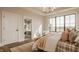 Bedroom featuring large windows, a bathroom entrance, and an elegant bed topped with decorative pillows at 3787 Cherwell Dr, Zionsville, IN 46077