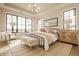 Bright and spacious bedroom featuring large windows, trey ceilings, a cozy bench, and decorative bedside tables at 3787 Cherwell Dr, Zionsville, IN 46077