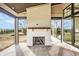Covered porch with a white brick fireplace and a wood mantel; the area offers an inviting outdoor space at 3787 Cherwell Dr, Zionsville, IN 46077
