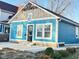 Charming blue home featuring a newer roof, a decorative beam, and white-trimmed windows for abundant natural light at 424 S Parker Ave, Indianapolis, IN 46201