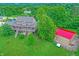 Aerial view of a house with a wrap-around porch next to a red roof outbuilding at 4590 Turkey Track Rd, Martinsville, IN 46151