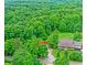 Beautiful aerial perspective of a home, outbuilding, and surrounding lush, dense forest at 4590 Turkey Track Rd, Martinsville, IN 46151