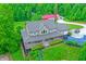 Stunning aerial view of home with wraparound porch, lush landscaping, and verdant green surroundings at 4590 Turkey Track Rd, Martinsville, IN 46151