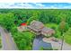 Aerial view of a property with a home and a red-roofed outbuilding surrounded by lush greenery at 4590 Turkey Track Rd, Martinsville, IN 46151