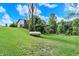 Expansive backyard featuring a gentle slope with lush green grass and a propane tank at 4590 Turkey Track Rd, Martinsville, IN 46151