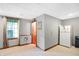 Carpeted basement space featuring a window, a door, a refrigerator, and a dropped ceiling at 4590 Turkey Track Rd, Martinsville, IN 46151