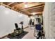 The basement gym features various equipment, with carpeted floors and exposed ceiling at 4590 Turkey Track Rd, Martinsville, IN 46151